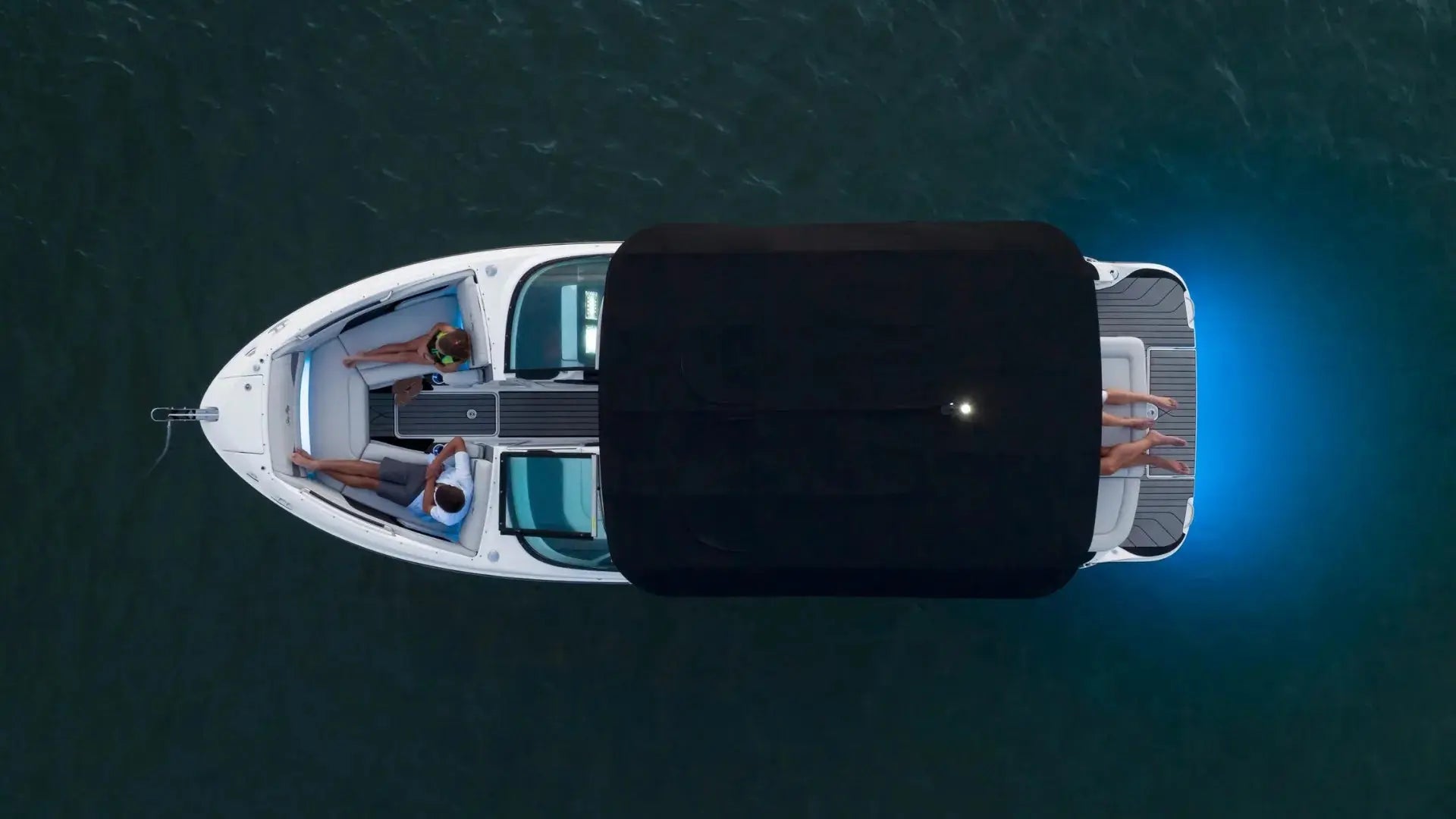 Aerial view of boat with EVA foam flooring, people relaxing inside