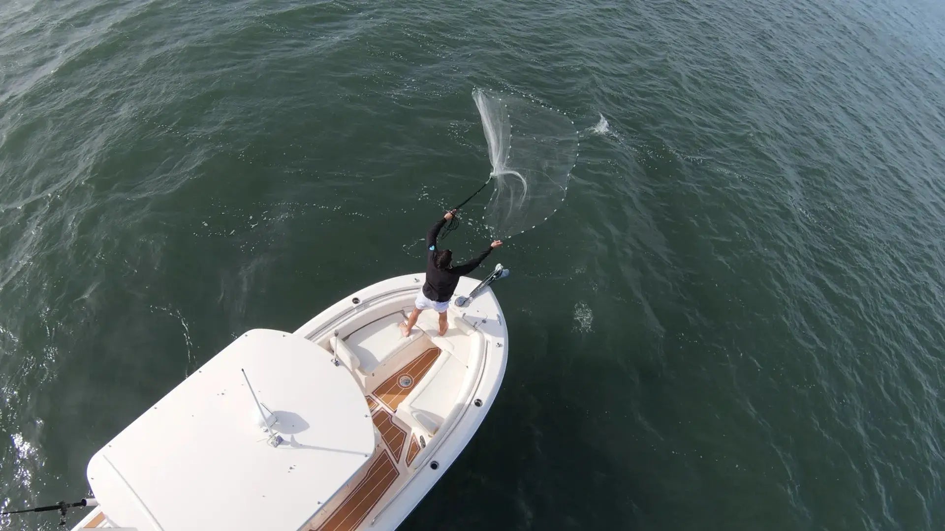 Person fishing on small boat with EVA foam flooring from BoatFloorings