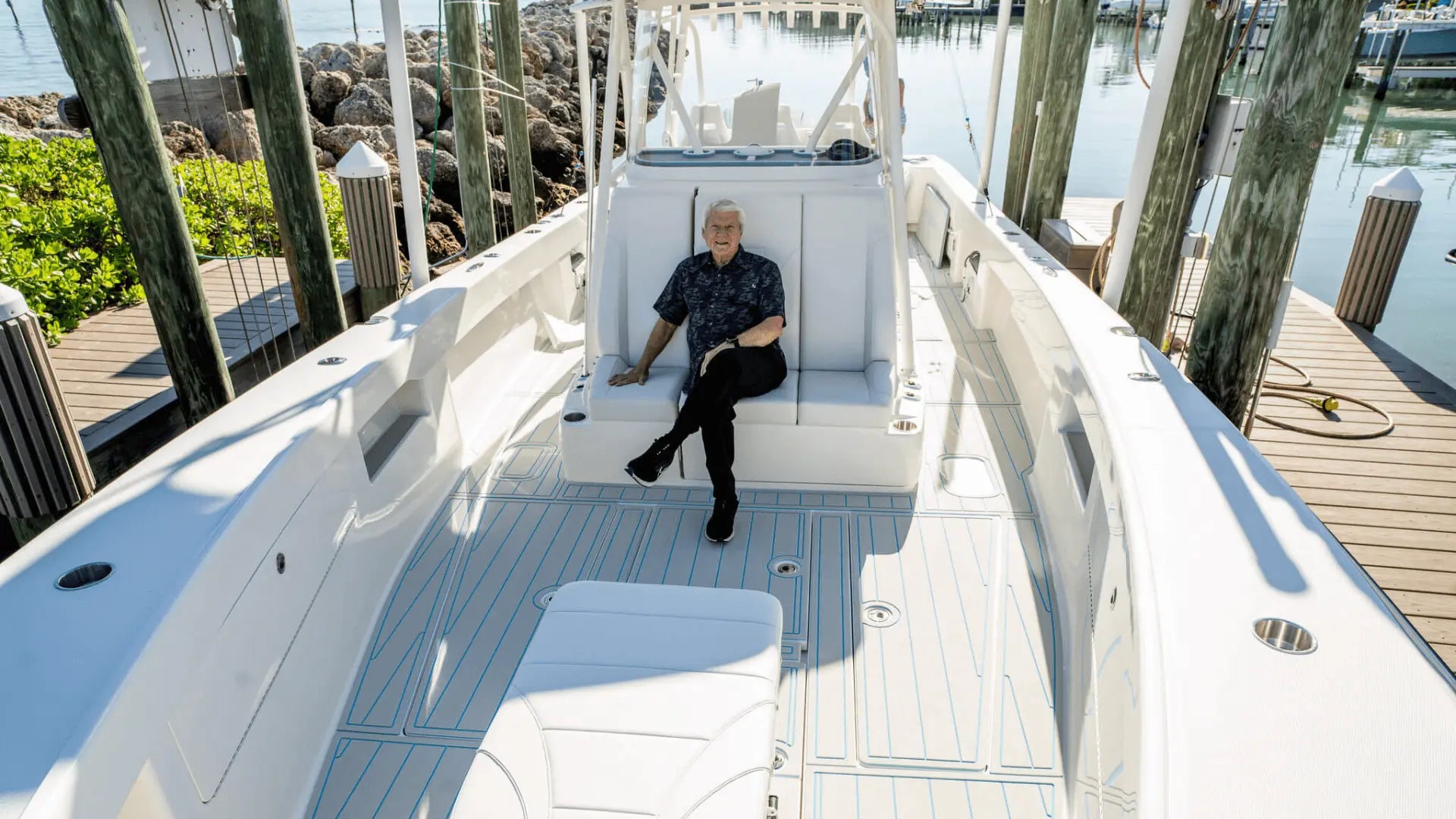 White boat interior with blue-lined EVA foam deck at marina