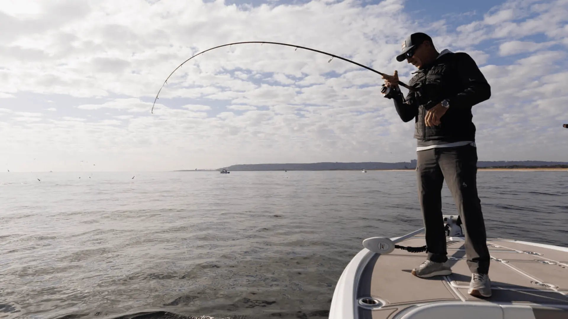 Person fishing on pontoon with BoatFloorings EVA foam flooring