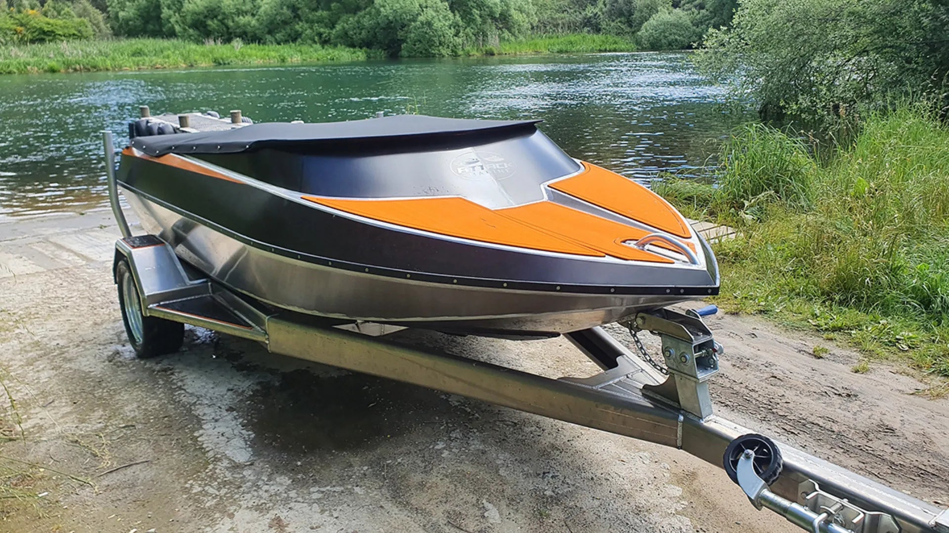 Black and orange EVA foam boat flooring on trailer by river