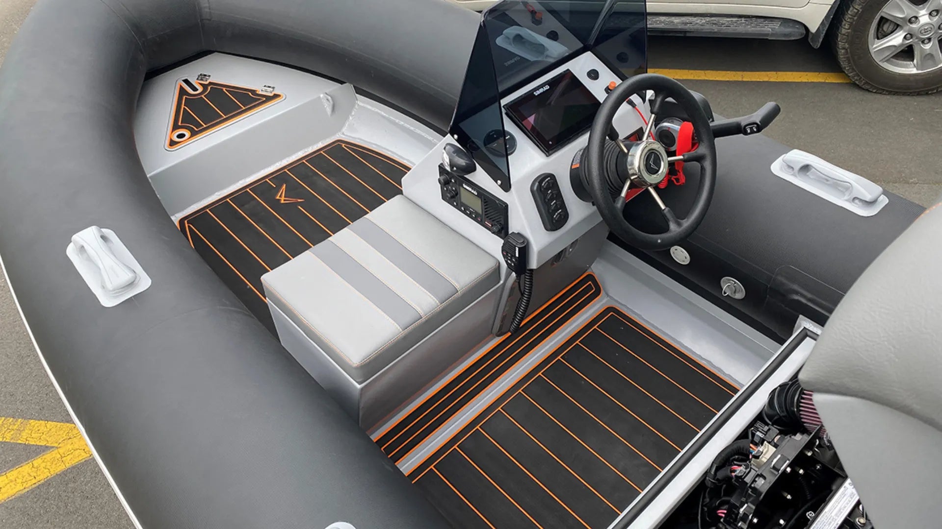 Inflatable pontoon boat featuring black EVA foam flooring for comfort